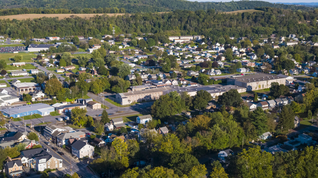 Aerial scenic view of the small American town lying along with the Lehigh River and historical Lehigh Chanel used for coal transportation, Lehigh Valley, Pennsylvania, USA, on a sunny evening in the early autumn.