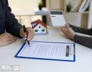 Real estate agents calculate and quote the cost of house with a calculator.