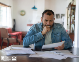Worried Individual Reviewing Finances Ft