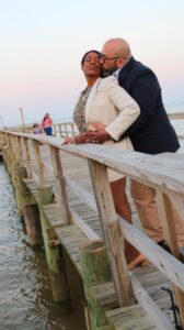 Stephen and Phyllis Guasp embrace on a dock in Virginia, reflecting on the legacy of interracial love and freedom made possible by the Lovings.