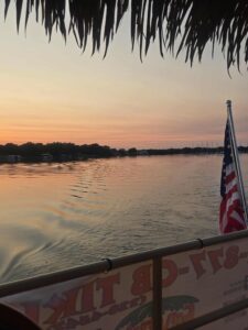 American flag on a tiki boat during a Monroe Bay sunset cruise.