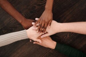 community-with-hands-in