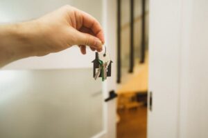 a person holding up house keys