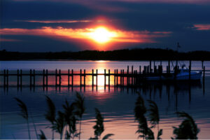Sunset over a quiet Middle Peninsula waterfront marina in Virginia representing peace, reflection, and returning home.