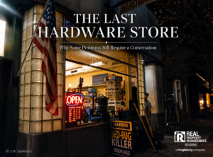 Small-town hardware store at night with an American flag and open sign, representing local businesses and community connection in the Virginia Northern Neck, Middle Peninsula, and Caroline County.