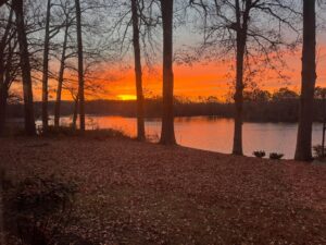 Sunset over a calm waterfront in the Virginia Northern Neck representing reflection, long-term rental property ownership, and thoughtful decision-making.