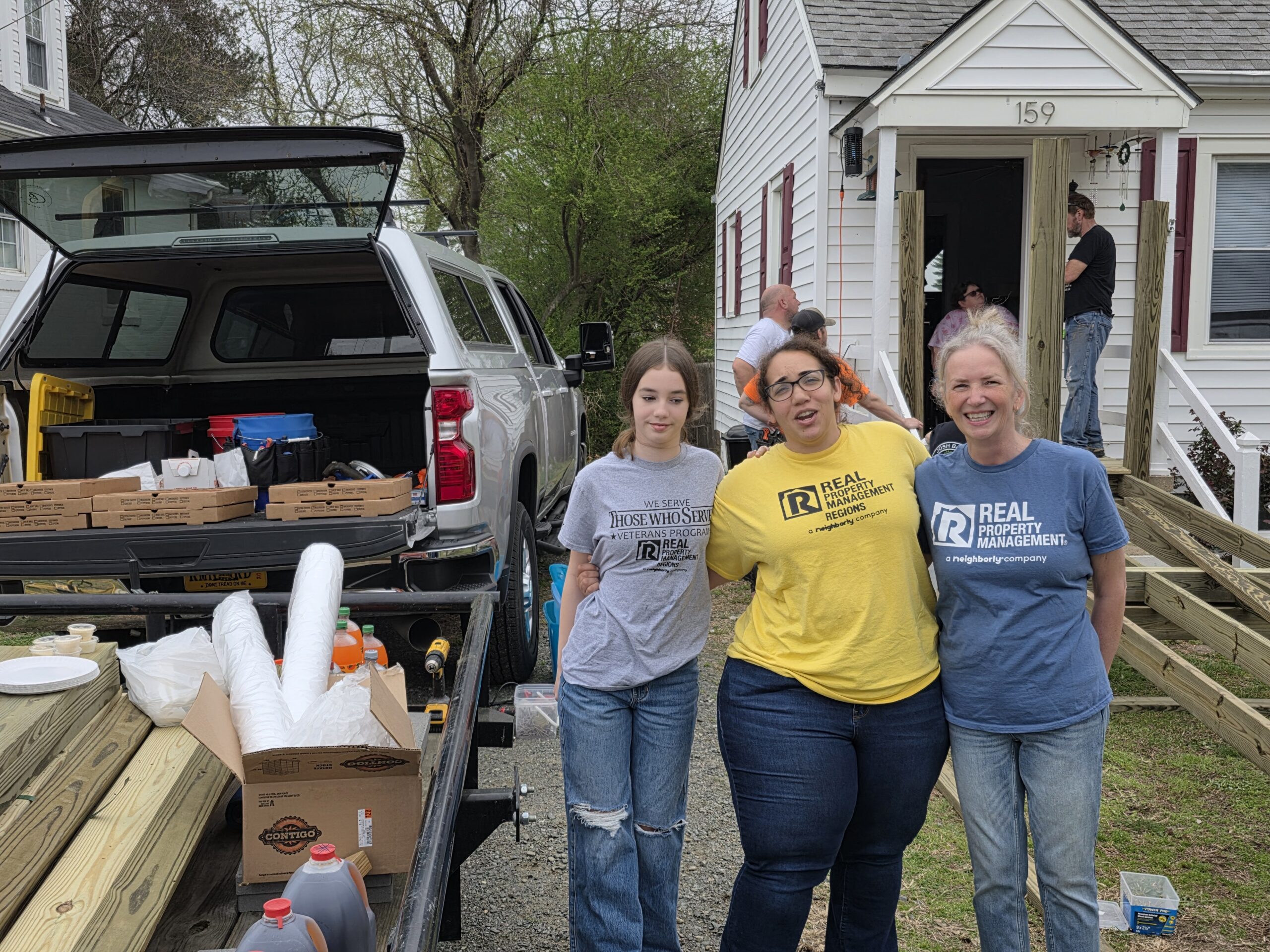 Real Property Management Regions volunteer team collaborating on a community service project.