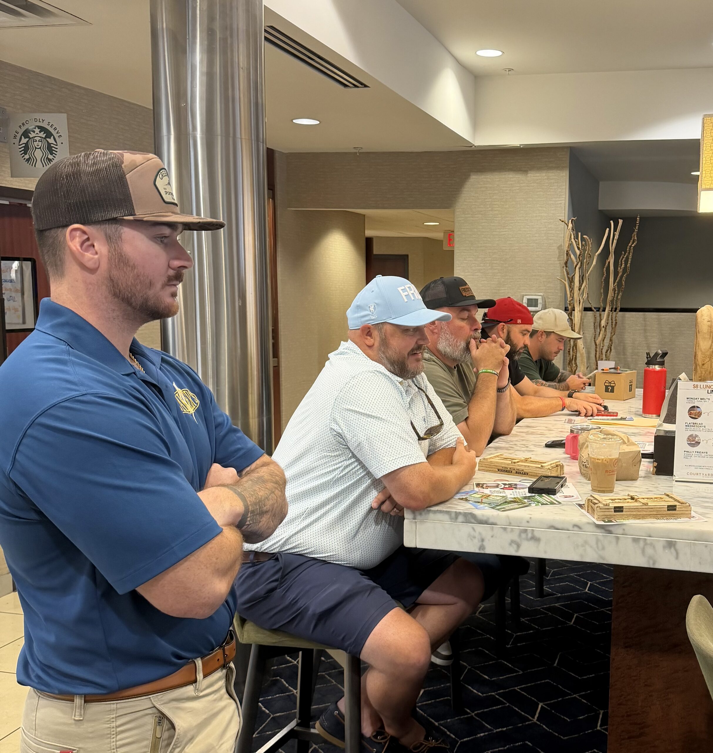 Local business owners, skilled trades professionals, volunteers, and community partners meeting to plan the inaugural Real Property Management Regions Day of Service.