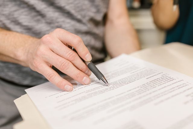 a person reviewing a contract to sign