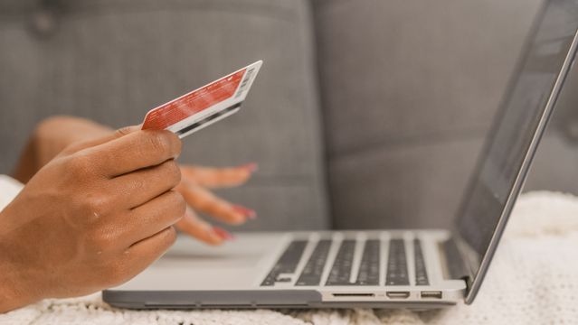 a person making a card payment at their laptop