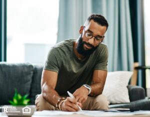 Young man filling out an application to rent a home.