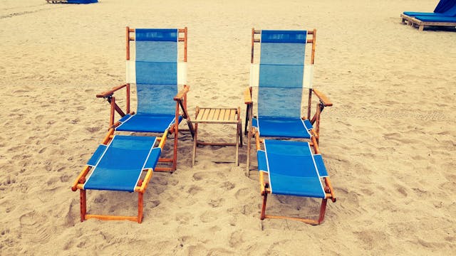 Beach chairs sitting in the sand