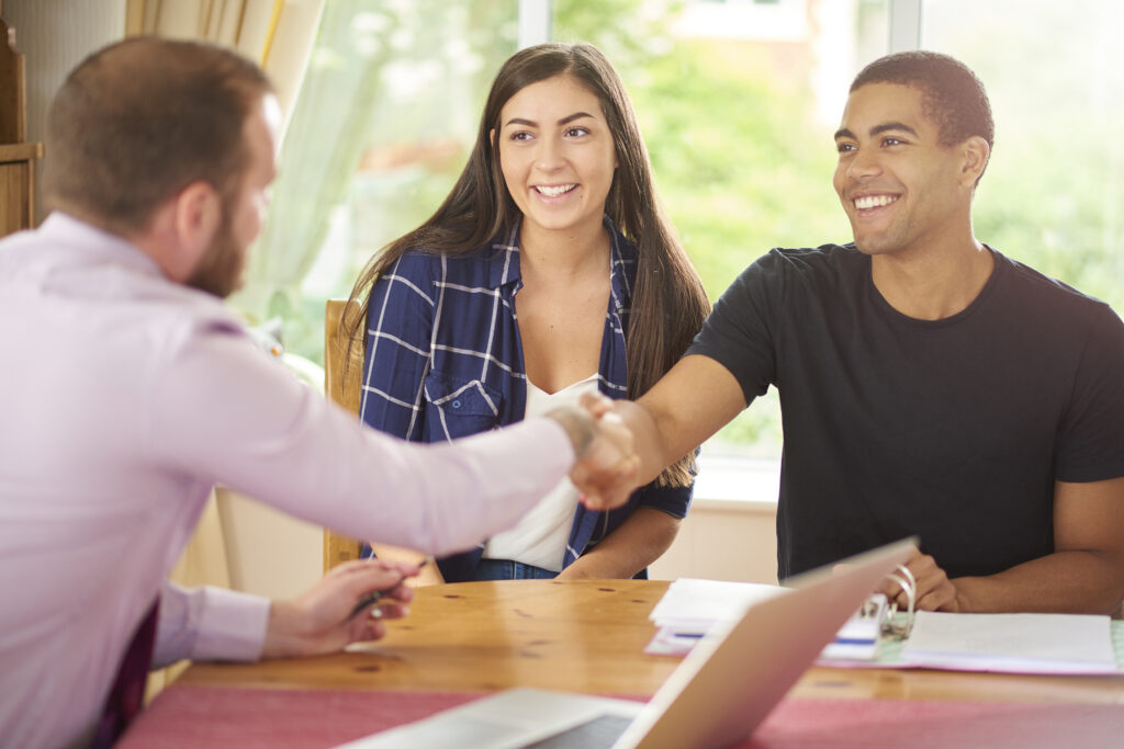 people shaking hands across a desk