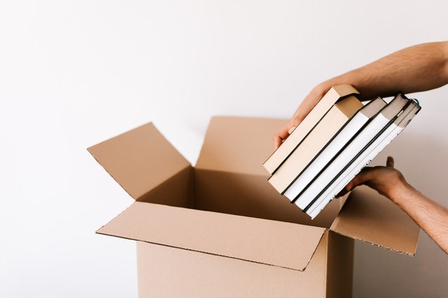 a person packing moving boxes
