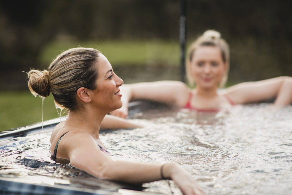Young Women Relaxing in Hot Tub on Rental Property