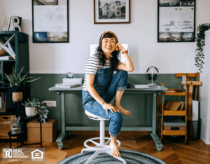 Cheerful, casually dressed woman sitting at the desk at home office.