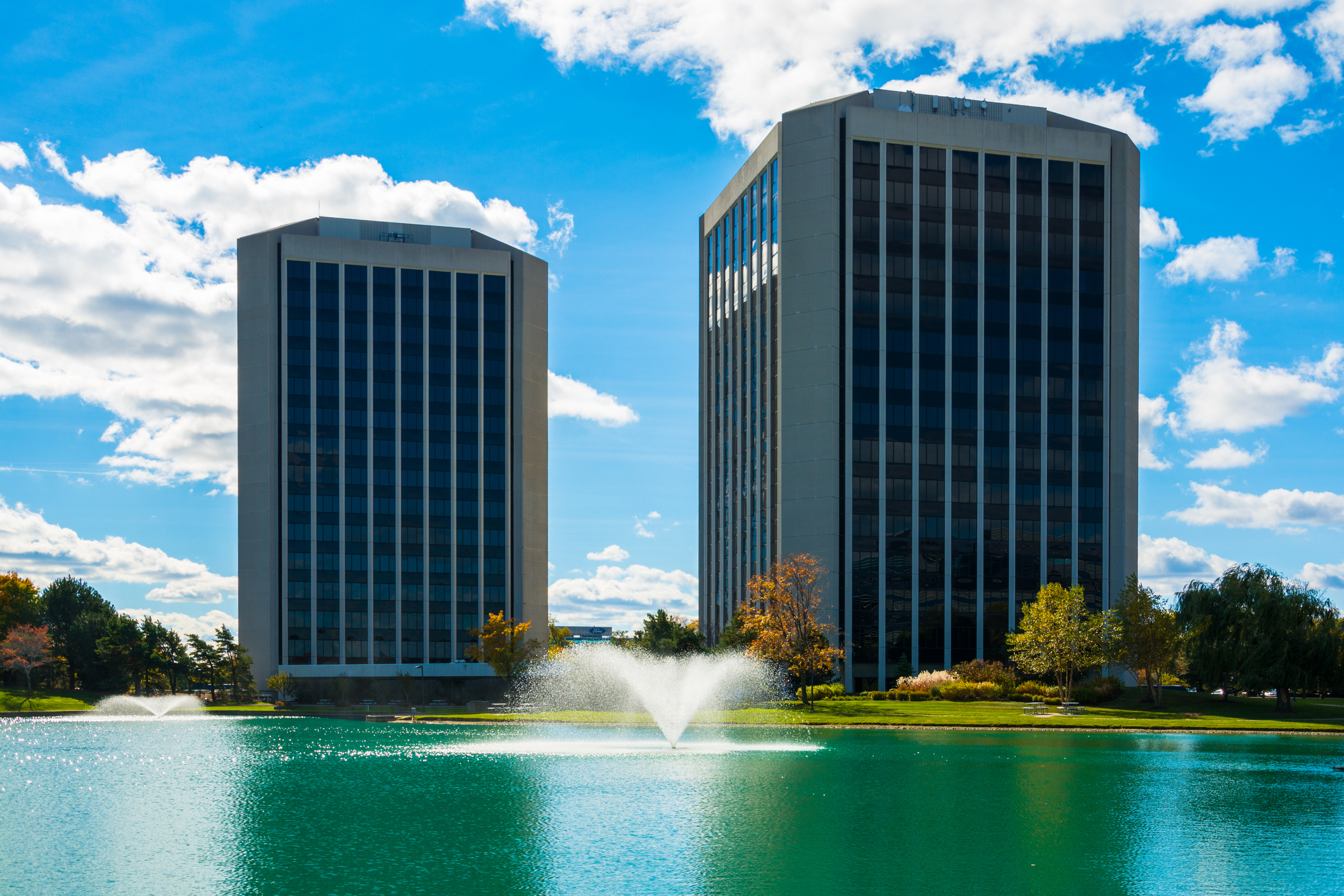 Park Lane Towers, a twin tower office complex in Dearborn, Michigan, with a pond with water fountains in the foreground. Dearborn is a part of the Metro Detroit area.