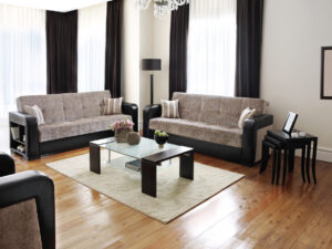 A cozy living room with a couch, coffee table, and hard-surface floors
