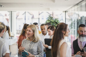 Group of people at a networking event, representing various real estate backgrounds.
