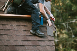 A person working on the roof of a house.