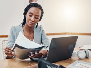 Woman gathering documents, prospective renter perfecting rental application. 
