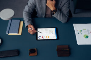 Man focused on a tablet displaying key property management metrics.
