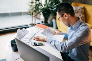 Real estate investor calculating the costs of a recent acquisition.

