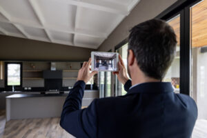 Real estate professional creating a virtual showing of a property using a digital tablet. 