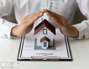 Man holds a house model above an insurance plan.