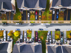 Aerial view of a bustling city street with cars and pedestrians below. 