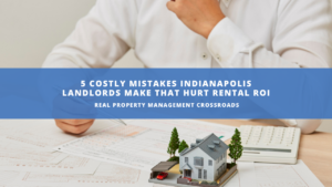 person that has papers and calculator spread out with a miniature version of a house in front of them