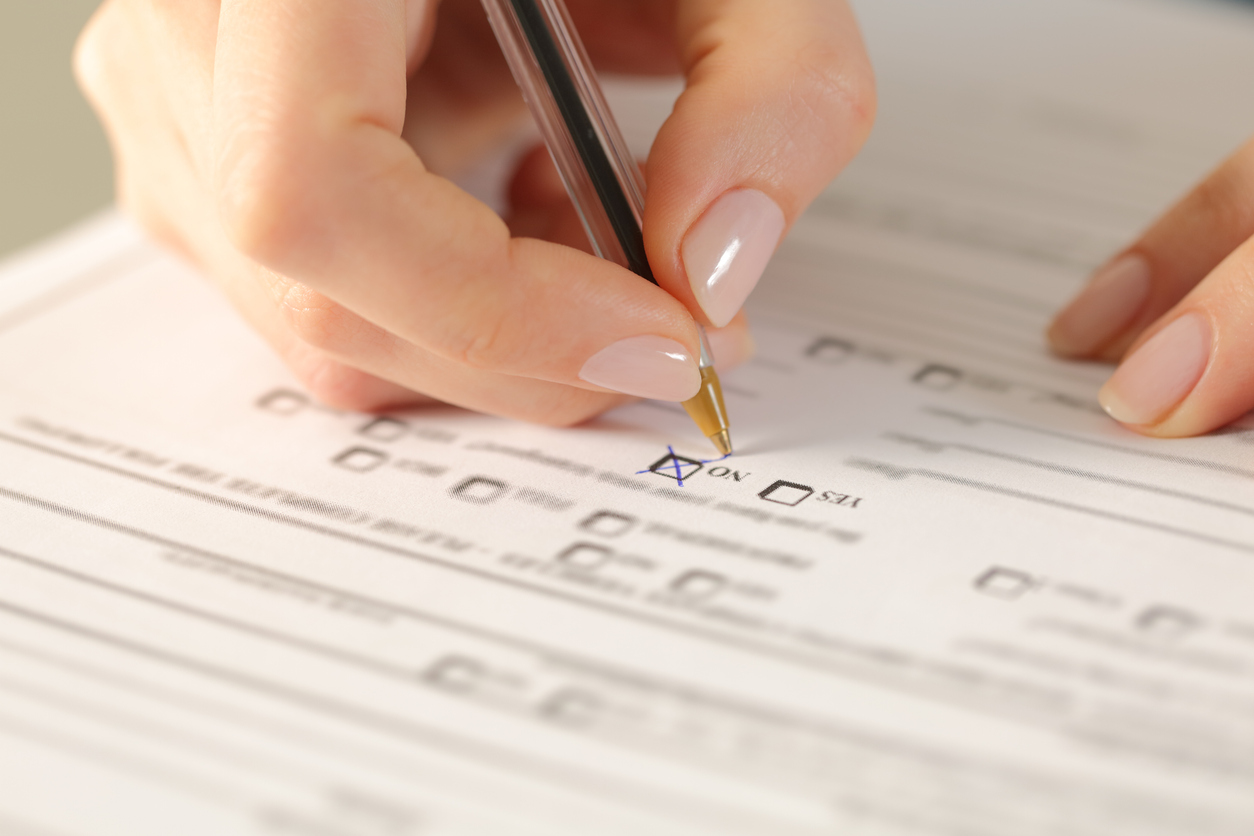 Cropped view of a Person Filling out a Checklist