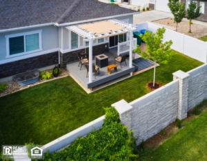 A cozy backyard featuring a patio area surrounded by a wooden fence, perfect for outdoor relaxation.