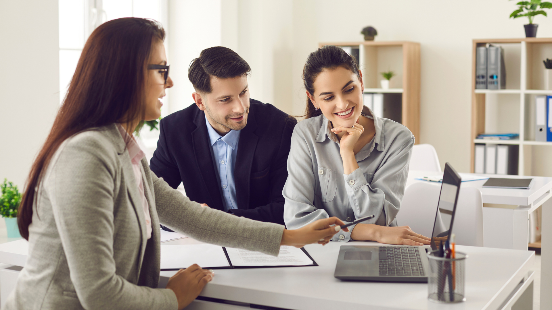 Three people reviewing a lease on a computer screen
