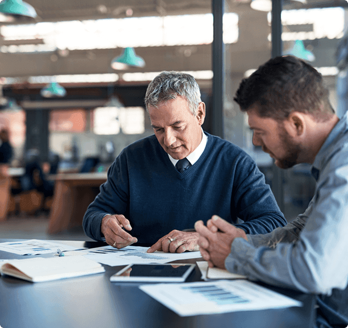 Two people reviewing a contract in an office