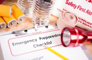Emergency preparedness checklist with flashlight, batteries, and first-aid supplies.
