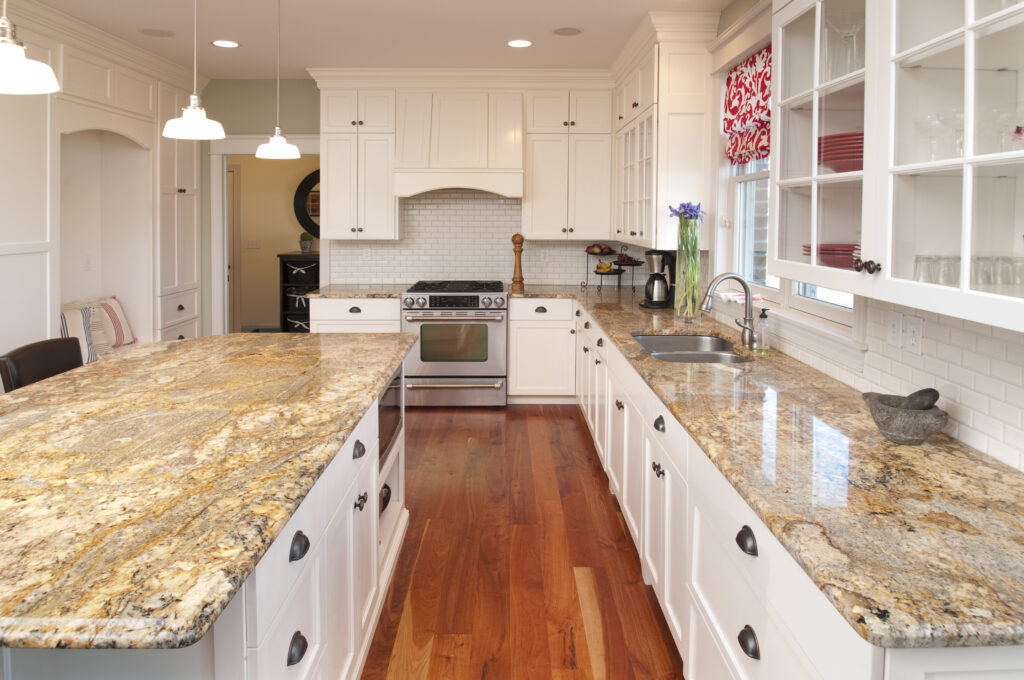 This spacious kitchen features marble counters and center counter, stunning hardwood cabinets and floor.