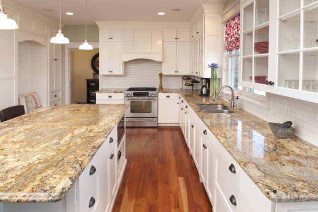 This spacious kitchen features marble counters and center counter, stunning hardwood cabinets and floor.