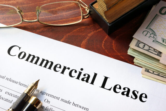 Commercial Lease agreement with money on a table. Commercial Lease agreement with money on a table.