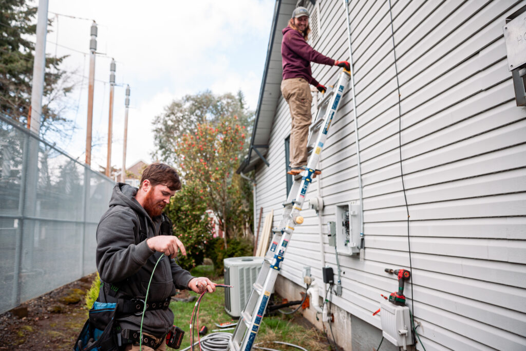 Electrician Wiring Up Solar Panel System on Home