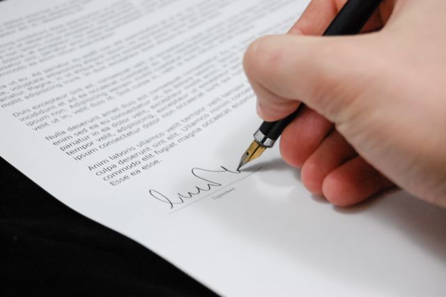a person signing an example contract