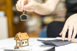 Property manager hands out keys to tenants after signing the lease.