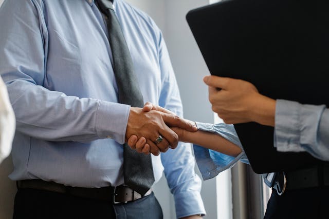 person-in-suit-shaking-hands