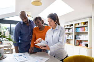 Property manager talking to a couple about lease terms and policies before they sign a lease and move in.

