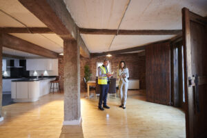 Contractor with real estate professional discussing loft apartment remodel.