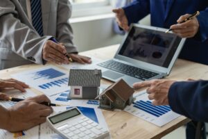Property managers review documents on a table.