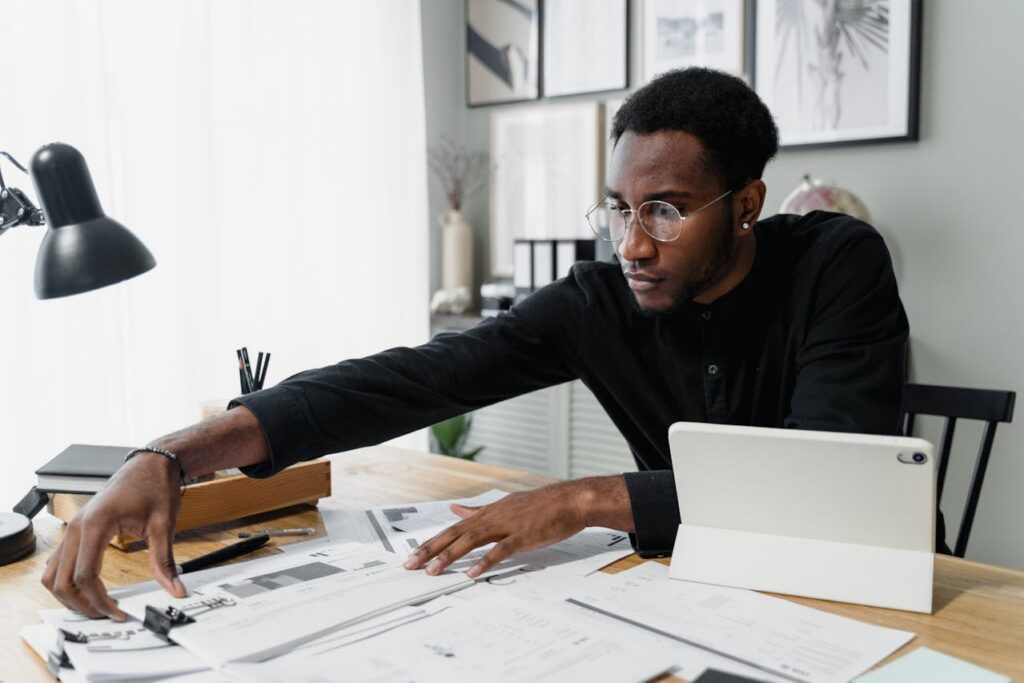 person looking at papers on desk