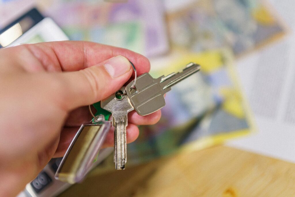 person holding keys scaled