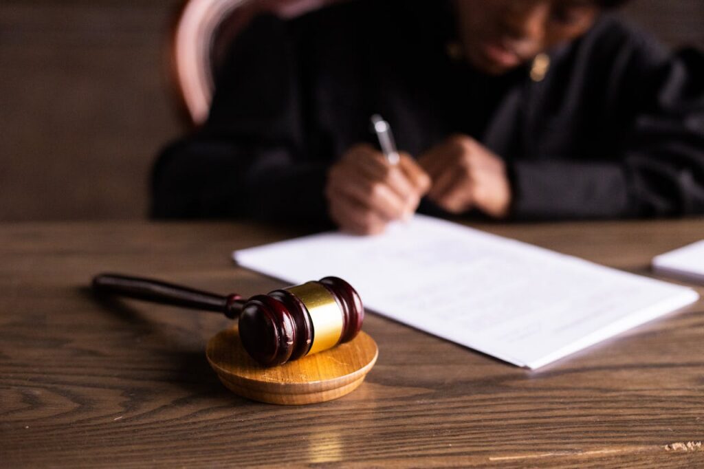 gavel in foreground and person writing in background