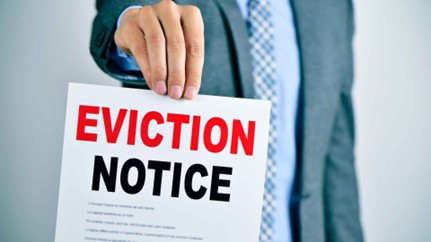 person holding eviction notice sign